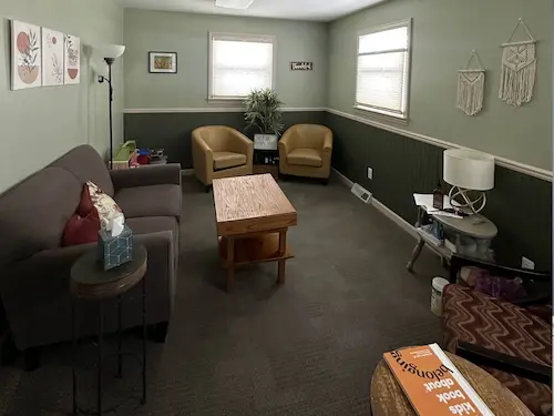 Play equipment and homely seating combine to offer a calming environment for children to express themselves